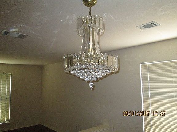 Wow.... what a chandelier!! No , not Waterford... however it brightens the room w a glow of warm lights and prisms..