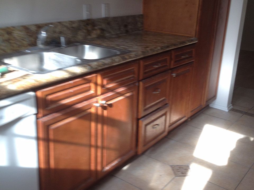 Custom kitchen tile and cabinetry with granite countertops a