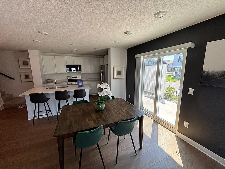 Kitchen shown in model-home photos for illustration purposes only. Actual home may vary in finishes, colors, and upgrades. The actual home does not include the patio door shown in the photos.