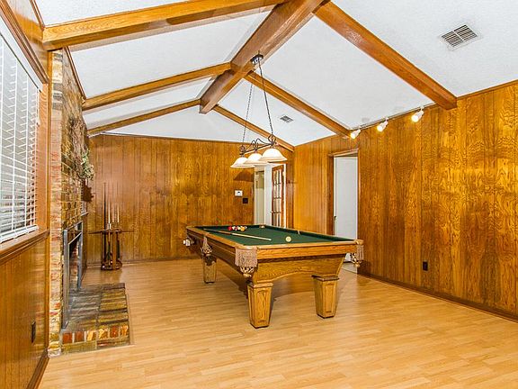 Family room has a high vaulted cathedral ceiling & laminate floors.