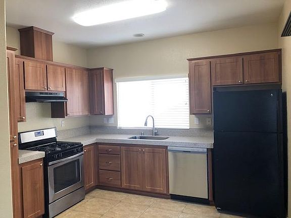 Bright kitchen with new cabinets, new granite and new dishwasher.