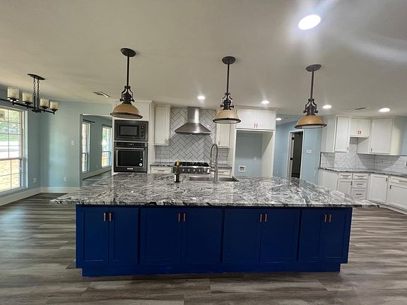 Granite counter top and huge island with ample counter and cabinet space