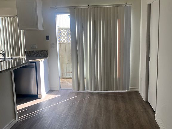 Dining room with vinyl flooring and custom lighting.