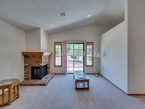 Living Room w/Fireplace and Landscaped Common Area in Back w/waterfall