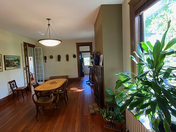 Huge windows let the sun stream in on the newly refinished original hardwood floors