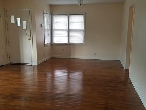 Living room. Looking from hallway towards optional dining area connected to the living room next the kitchen entrance.