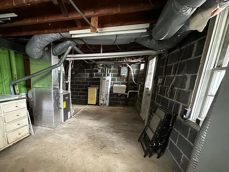 Unfinished walkout basement, laundry sink, washer/dryer hookups. Gas hot water heater and furnace.
