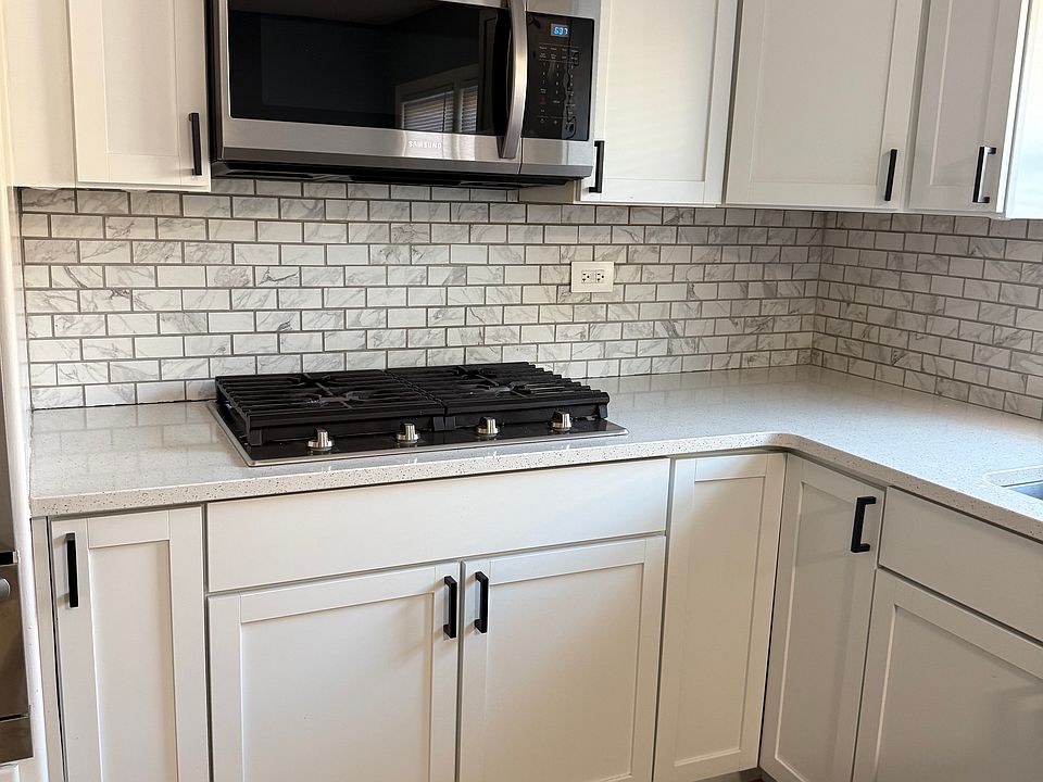 Stainless steel appliances and quartz countertops.