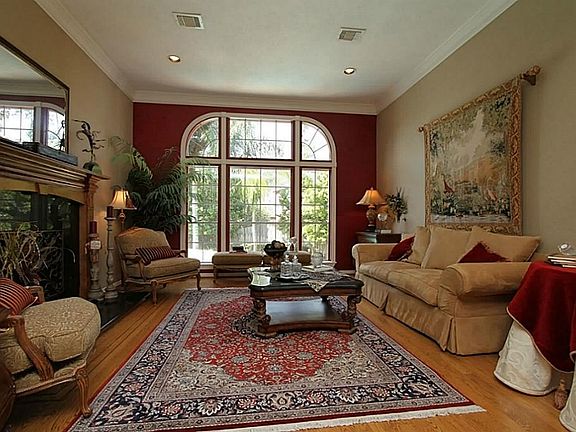 The Living Room features Oak Flooring with Custom  Inlay Trim and affords a great view of the pool and backyard