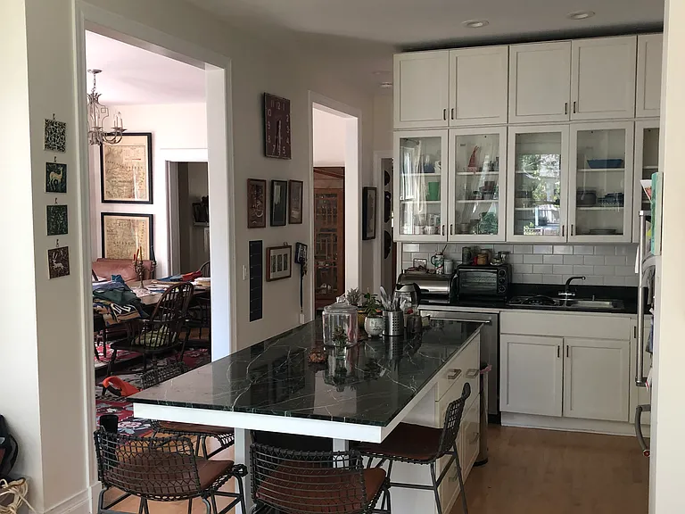 view from family room into kitchen with a peak into DR