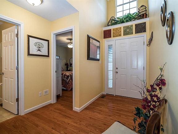 Wood, Wood and more wood floors all throughout the homes main level with the exception of the bathrooms and main floor laundry greeting you to this very well maintained home.  Notice the architectural space above the front door giving room for plants and other decor.  The dormer window offers an abundance of natural light.