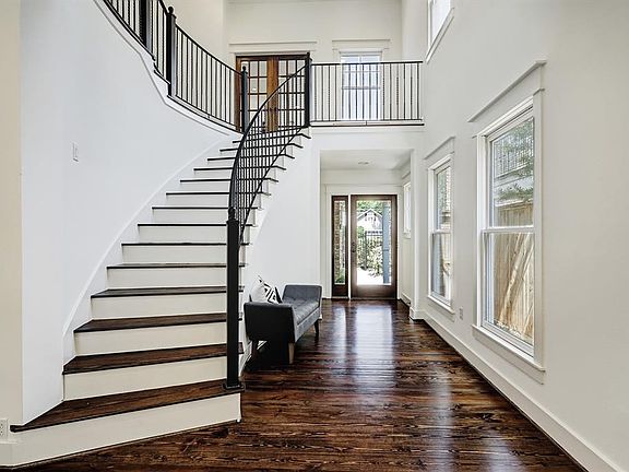 Dramatic two story entryway welcomes you with a beautiful curved staircase.