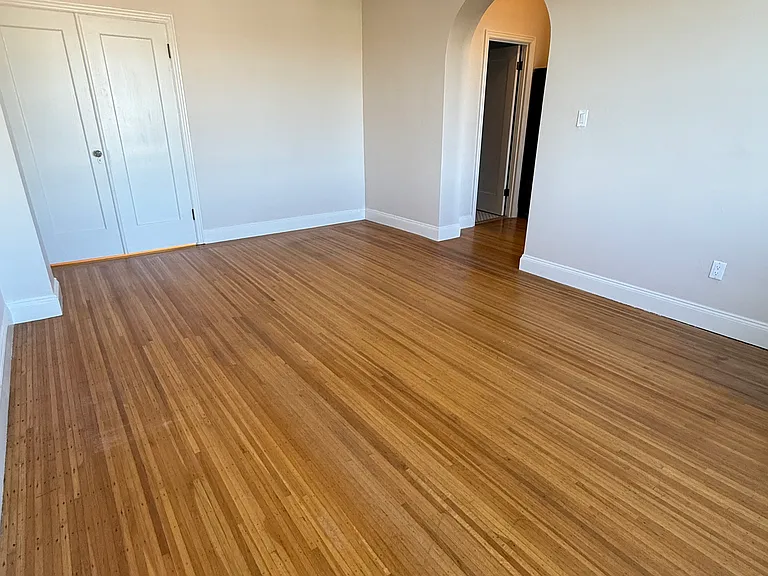 POV from corner of living room looking back at archway entrance.