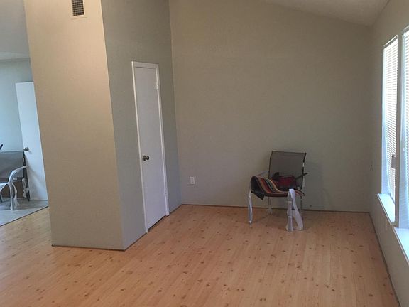 Living room with laminate floors and additional storage