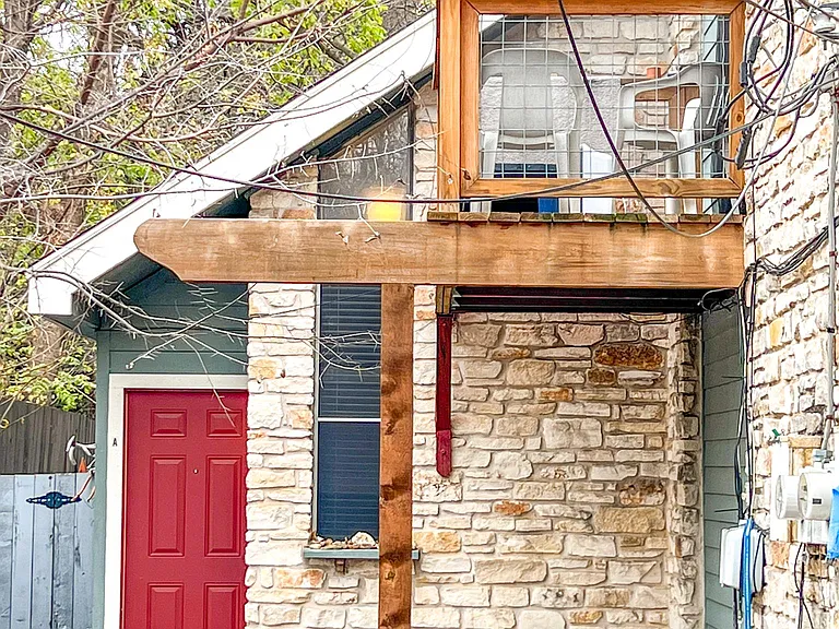 Cute red door. Also shows master bedroom balcony