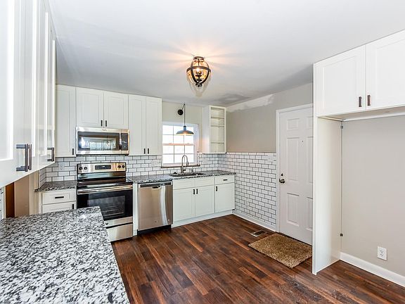 Fridge is not in photo, but there is a fridge in the empty kitchen space on the right.