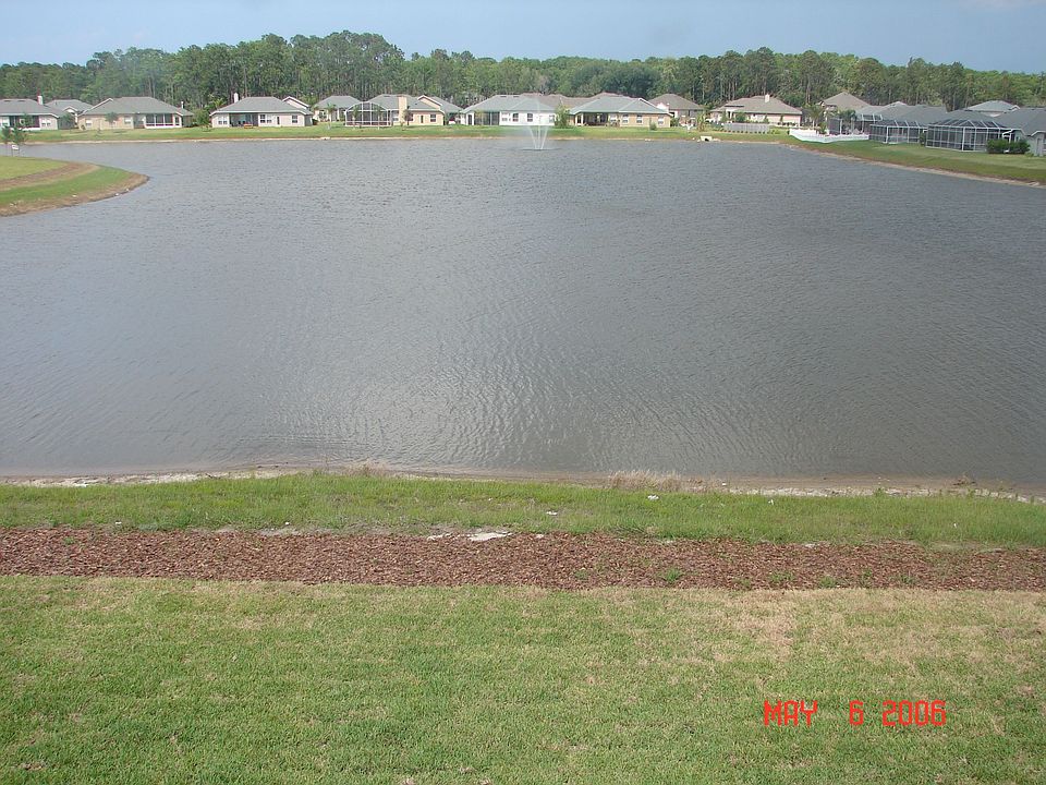 This photo of the backyard shows the lake and fountain. We took this just after the grass was laid down so it much nicer now.  The yard is huge and the home is on a cul de sac so it is very private.  You will love the lighted fountain and privacy of this big home