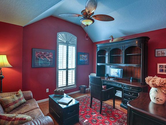 The study has just the right amount of privacy, a vaulted ceiling, custom fan and light fixture and solid wood floors.