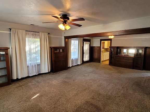 Living room view to dining room with built-in buffet cabinet
