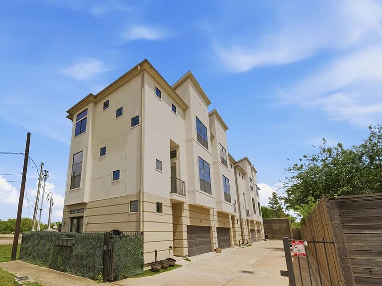 Modern three-story townhome with a sleek white exterior and spacious, well-designed layout. Large windows provide abundant natural light, complemented by a two-car garage and convenient access to nearby dining, shopping, and everyday amenities.