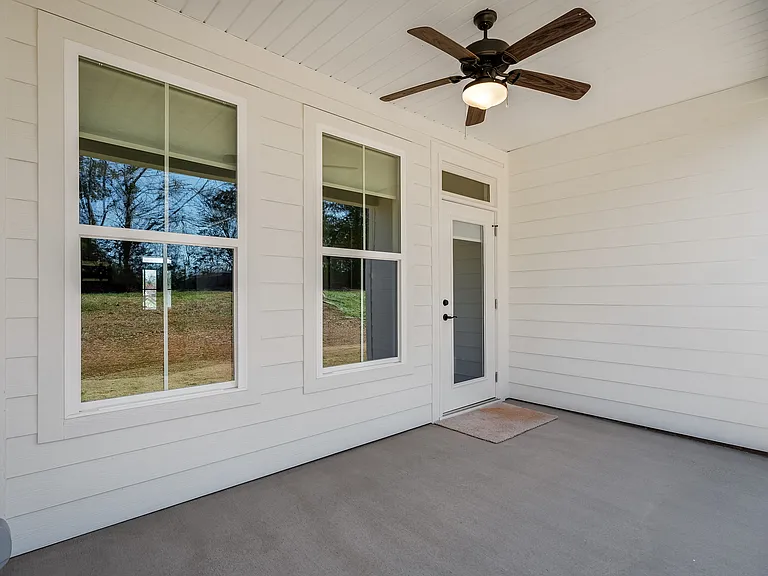 Private backyard covered porch with a distant view.