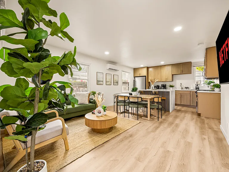 Open living room with smart TV, ideal for relaxing after enjoying nearby beaches, cafes, and attractions.