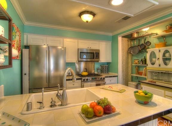 Stunning custom kitchen boasts Samsung & Jenn Air Appliances and huge pantry storage area. Designer 