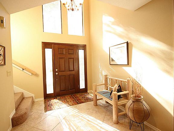 Inside, you will find a light and bright entry with tile floors and soaring ceilings.