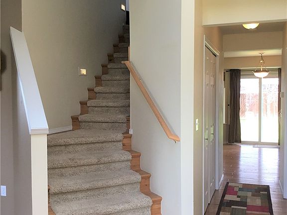 Wood and carpet stairway to 3 bedrooms, 2 baths and an office loft upstairs.