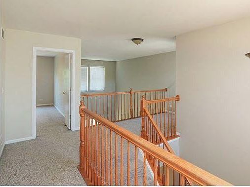 Upstairs loft/balcony area leading into large master bedroom that has a hallway of double closets leading into the full bathroom. Privacy with 2nd bedroom at the other end of the hallway.