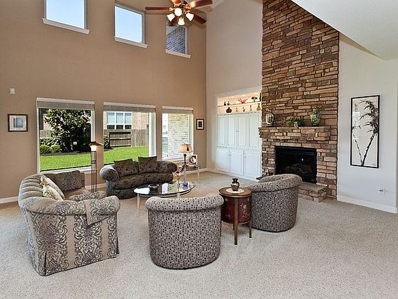 2 Story Ceilings, 24' stone mantle & wall of windows for in the Den