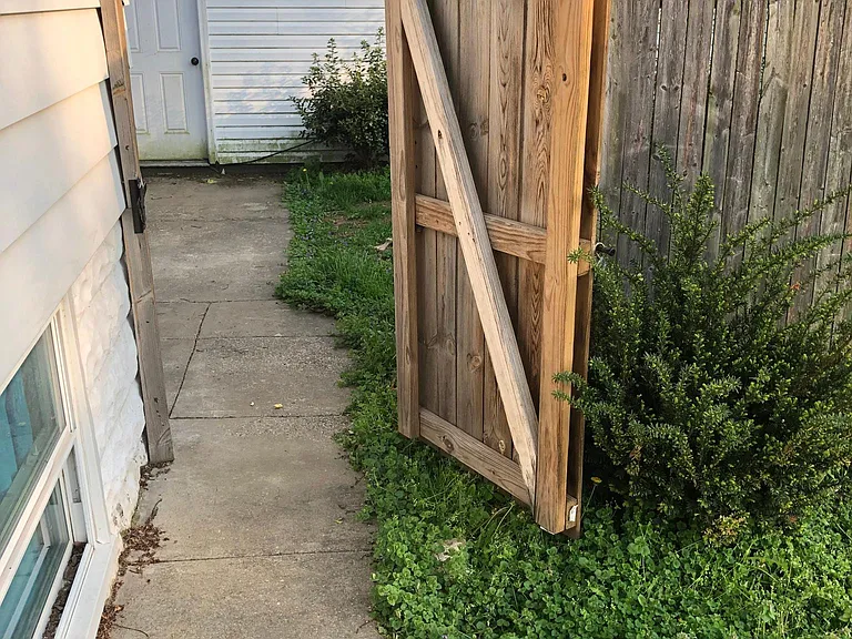 Fenced in back yard shares back fence line with Swiss Hall property