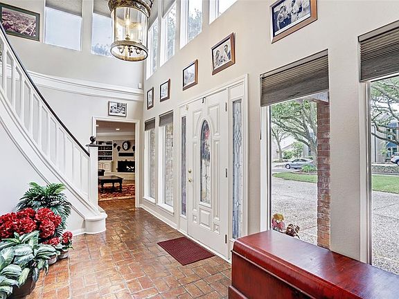 Exquisite 2 story Entry with circular stairway & floor to ceiling windows. Nothing dark here.