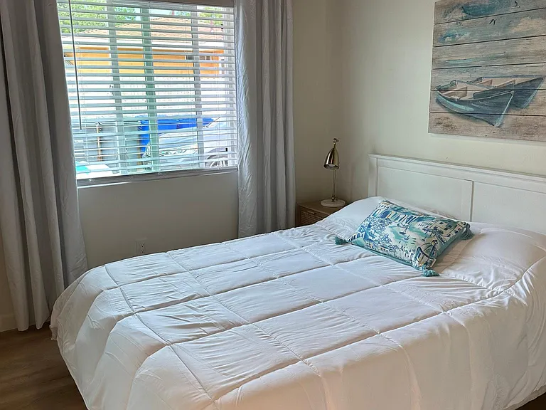 Nightstands with reading lamps, curtains and blinds are new, ceiling fan, mirrored closet doors. comfy queen bed.