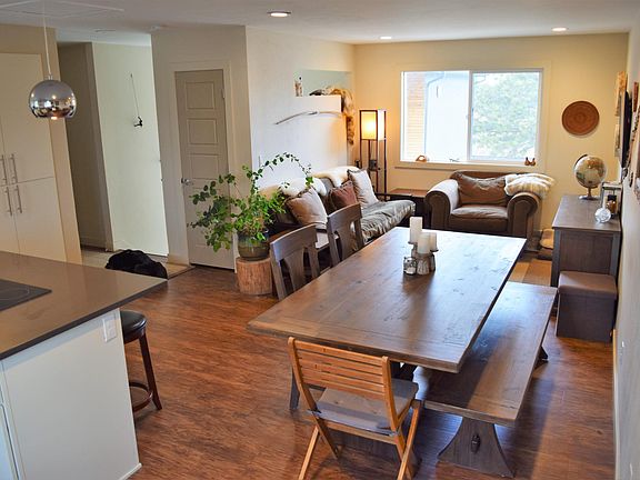 Open floor plan with kitchen, dining, and living spaces.