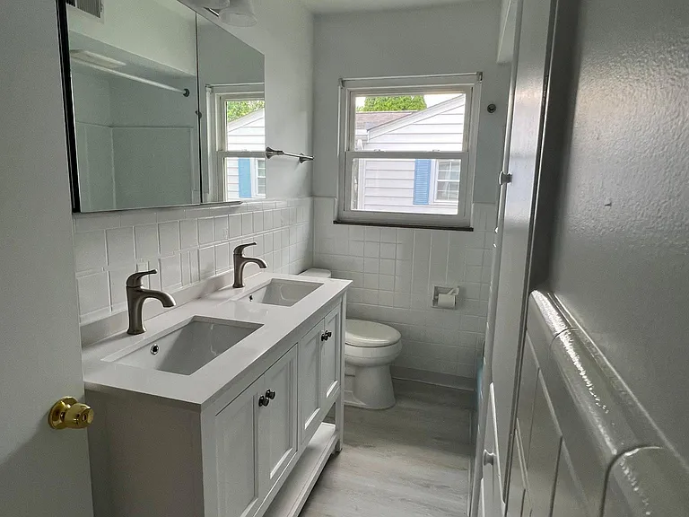 First floor full bath. Double sink, double medicine cabinet, built-in wall cabinet
