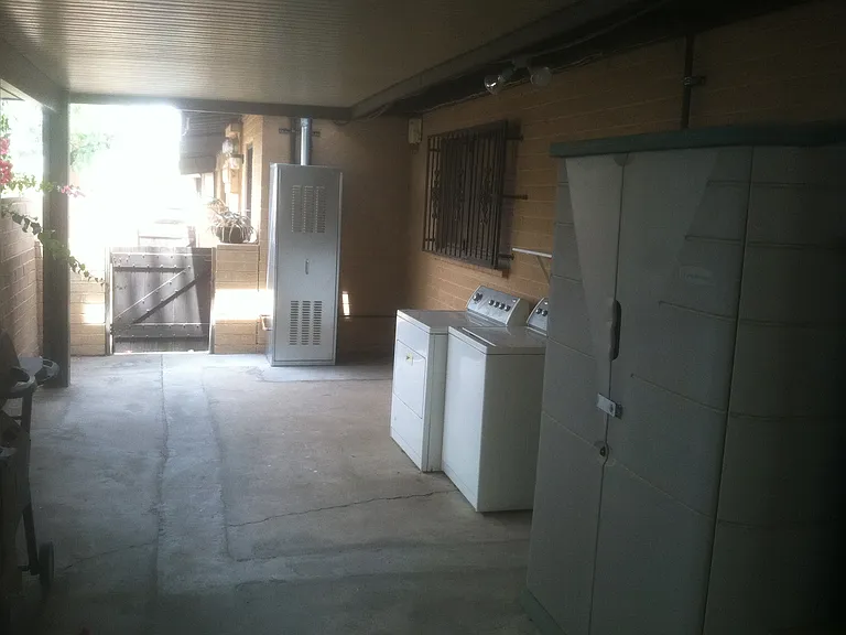 This unit has a covered walk-out patio at the back, a private washer and dryer, and a covered parking space.
