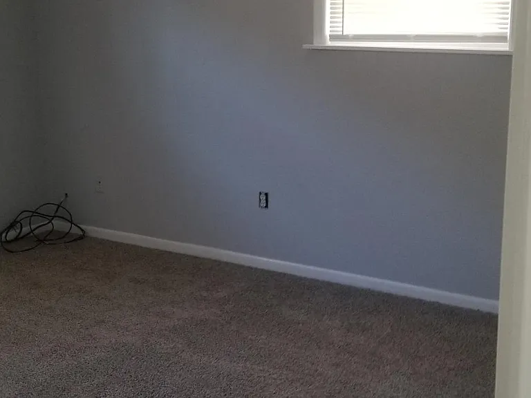 Rear bedroom with ceiling fan.