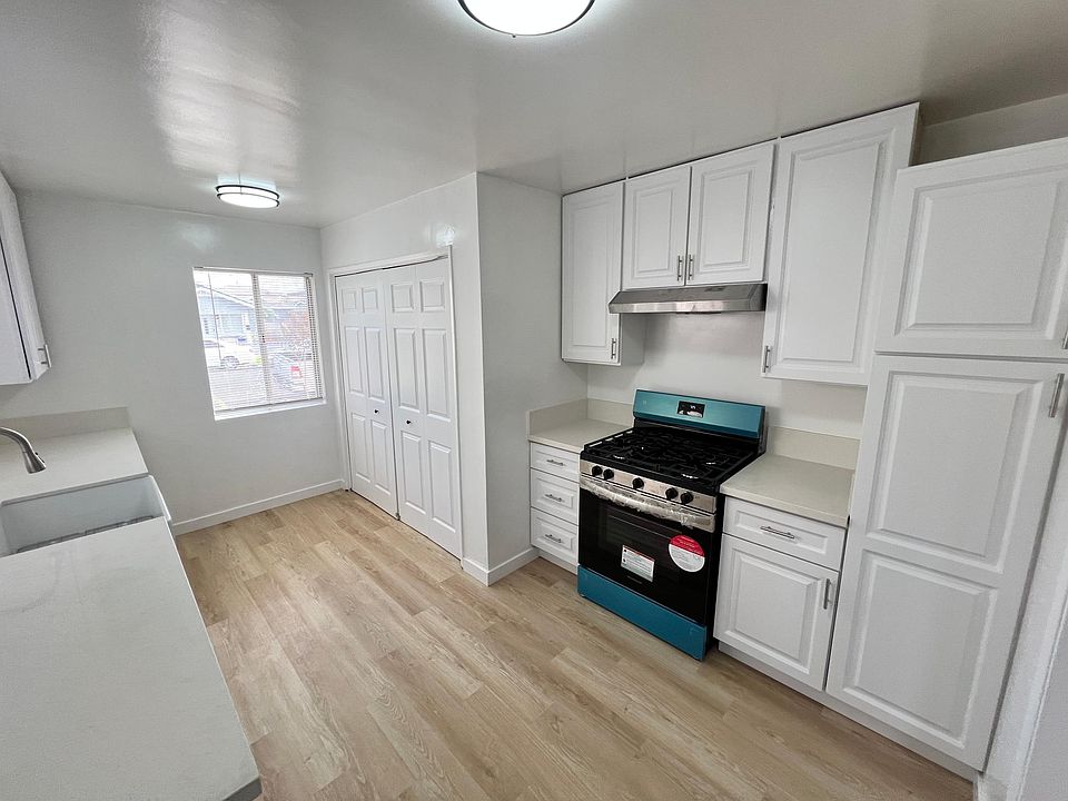 Kitchen with new stailess steel range and washer/dryer hookups
