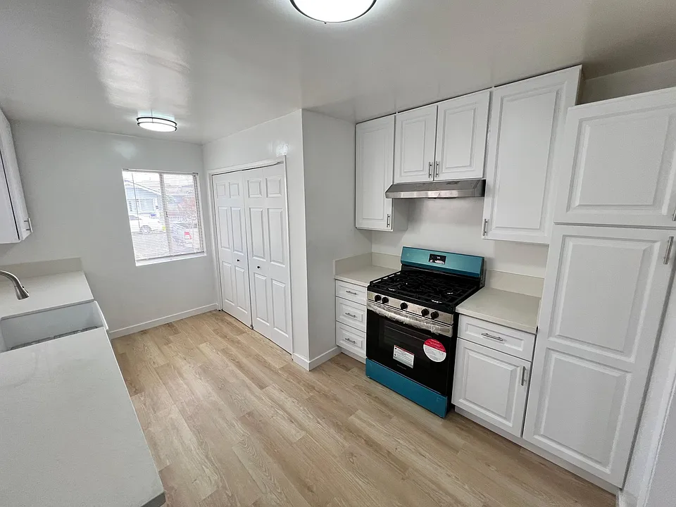 Kitchen with new stailess steel range and washer/dryer hookups