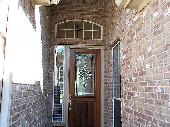Elegant 8' Mahogany door with leaded glass surrounded by all brick entry
