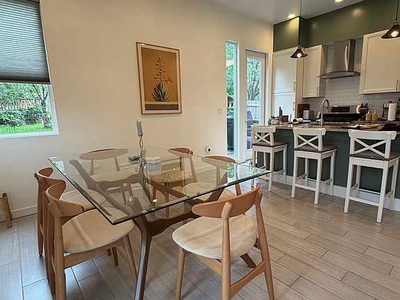 Kitchen with eat-at island and large dining room area.