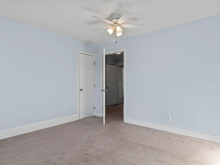 Bedroom door to living room and to Walk-in Closet