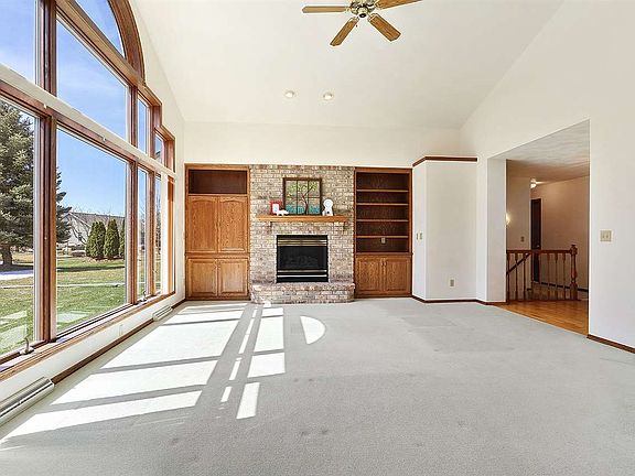 Stunning living room with soaring windows and gas fire place
