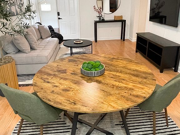 Open-concept dining and living area with 55" smart TV for relaxing after the day.