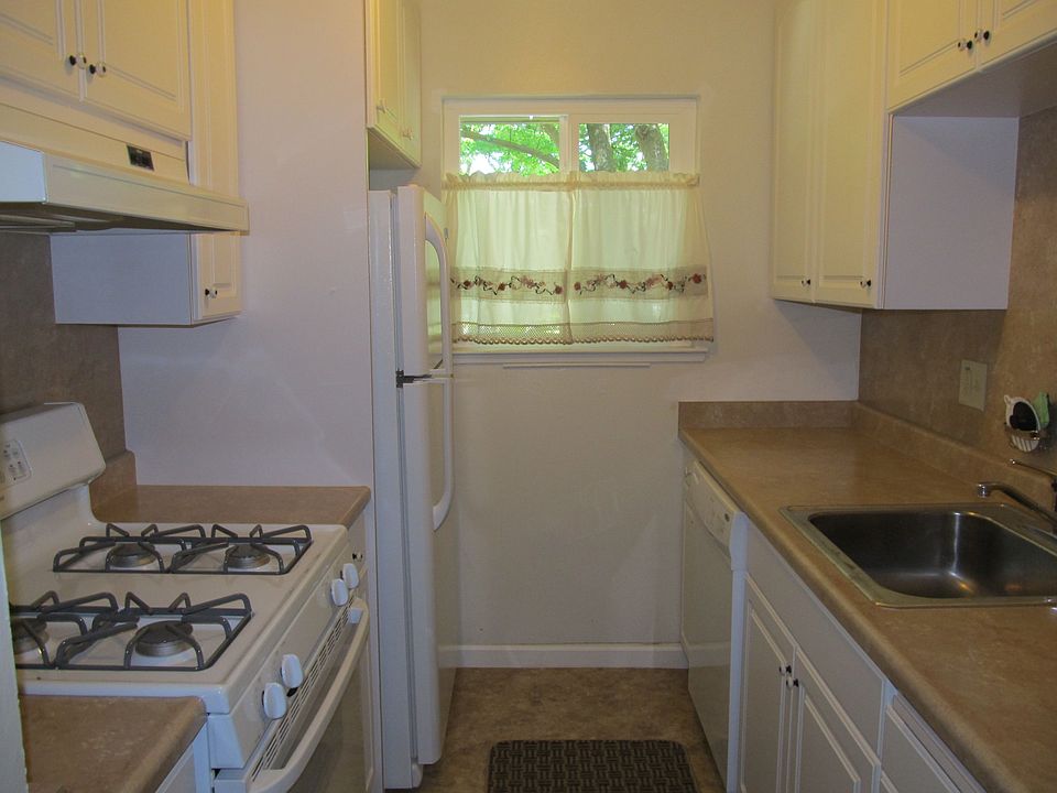 Kitchen features new appliances and cabinets, stainless sink, gas range.