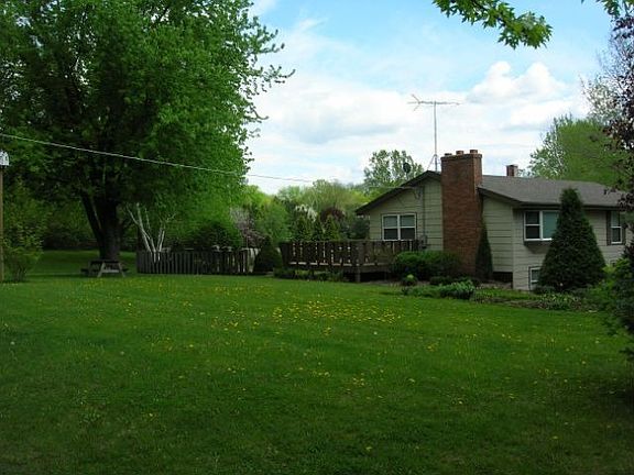 Large deck overlooks manicured yard