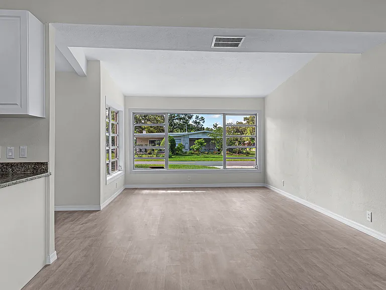 View to living room with large windows for extra light.