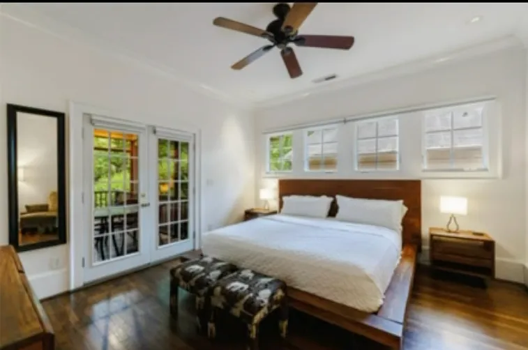 Primary bedroom opens up to screened in back porch