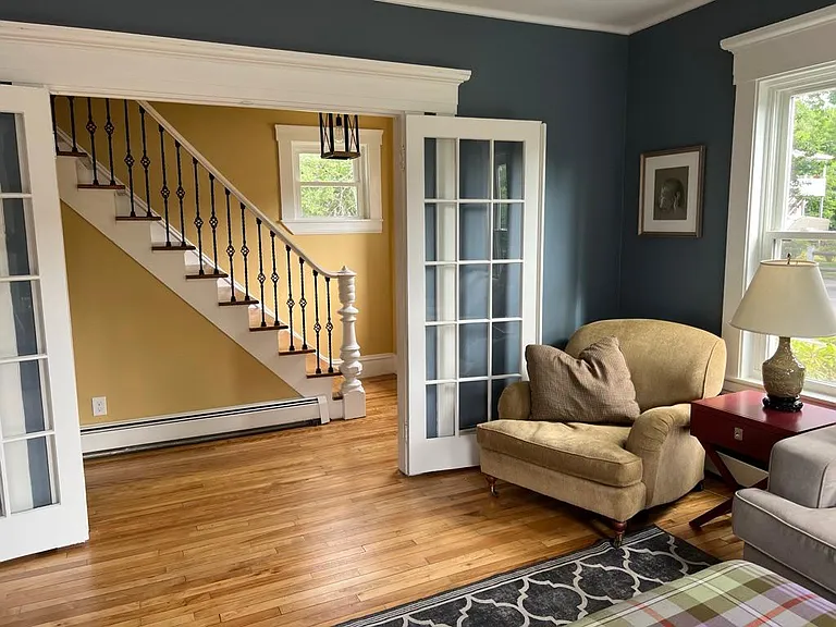 French doors from the Living Room open up to the hallway and front door